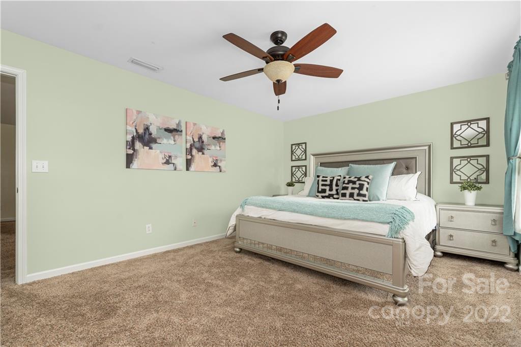 2219 Durand Road Fort Mill, SC 29715 - Photo 24 of 39 a bedroom with a large bed and a ceiling fan