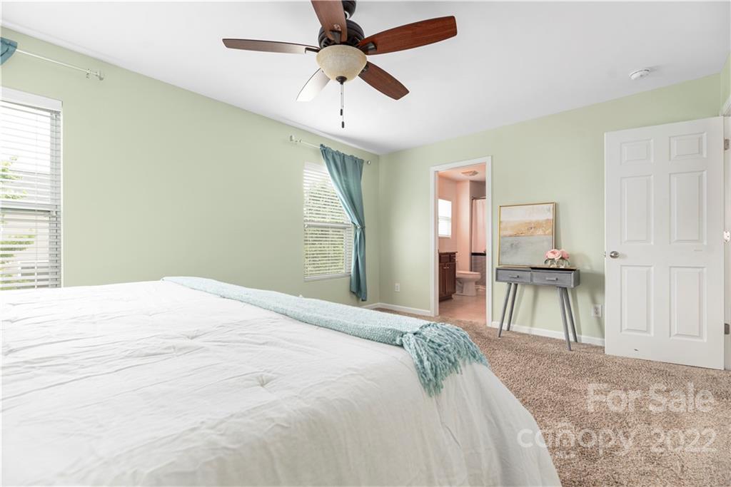 2219 Durand Road Fort Mill, SC 29715 - Photo 25 of 39 a bedroom with a bed and a chandelier