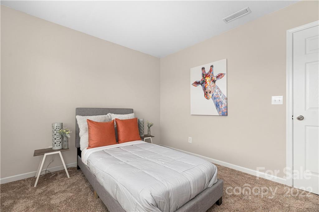 2219 Durand Road Fort Mill, SC 29715 - Photo 28 of 39 a bedroom with a bed and painting on the wall