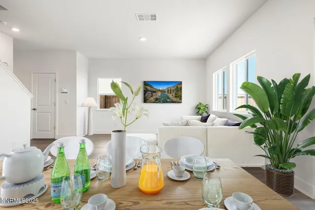 a kitchen with cabinets stainless steel appliances and wooden floor