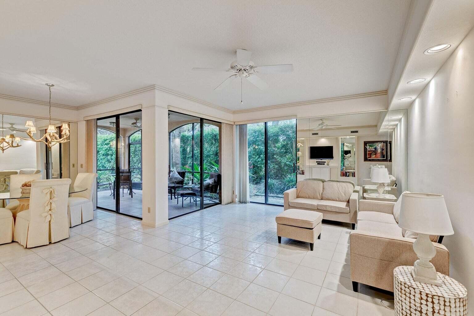 16151 West Bay Drive, Unit 161 Jupiter, FL 33477 - Photo 16 of 19 a living room with furniture and large windows
