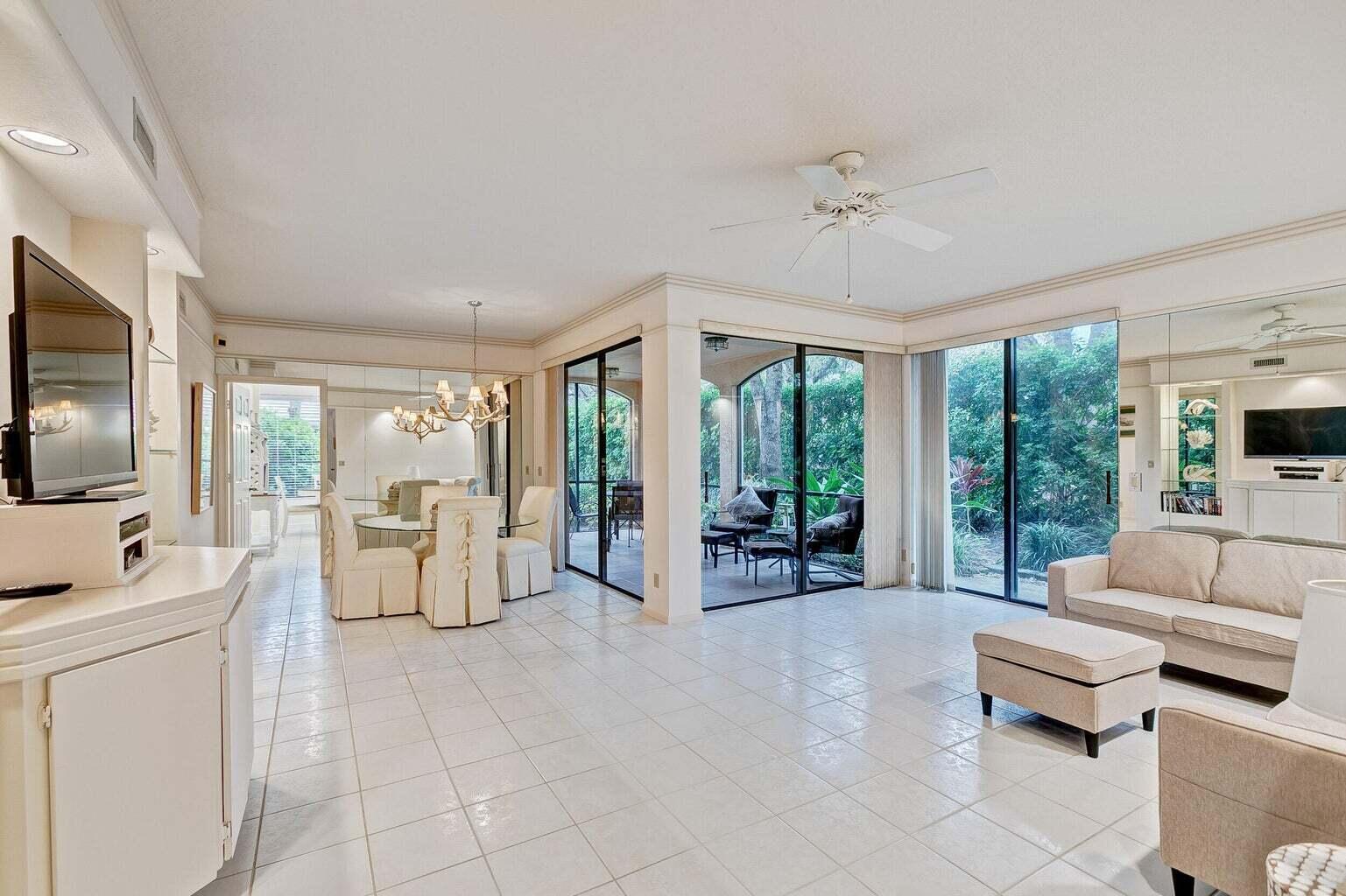 16151 West Bay Drive, Unit 161 Jupiter, FL 33477 - Photo 17 of 19 a living room with furniture and large windows