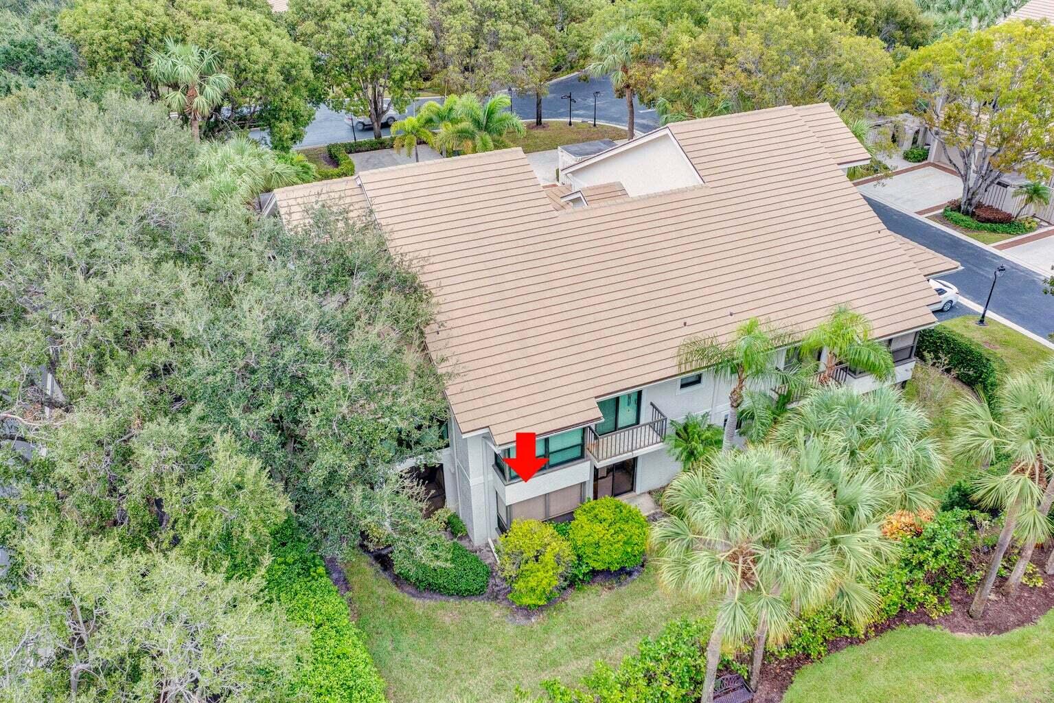 16151 West Bay Drive, Unit 161 Jupiter, FL 33477 - Photo 2 of 19 a aerial view of a house with yard and trees in the background