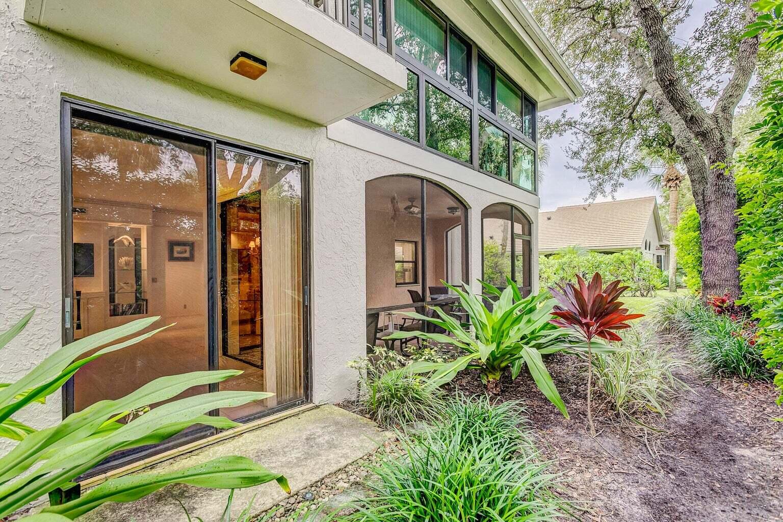 16151 West Bay Drive, Unit 161 Jupiter, FL 33477 - Photo 4 of 19 a front view of a house with a yard