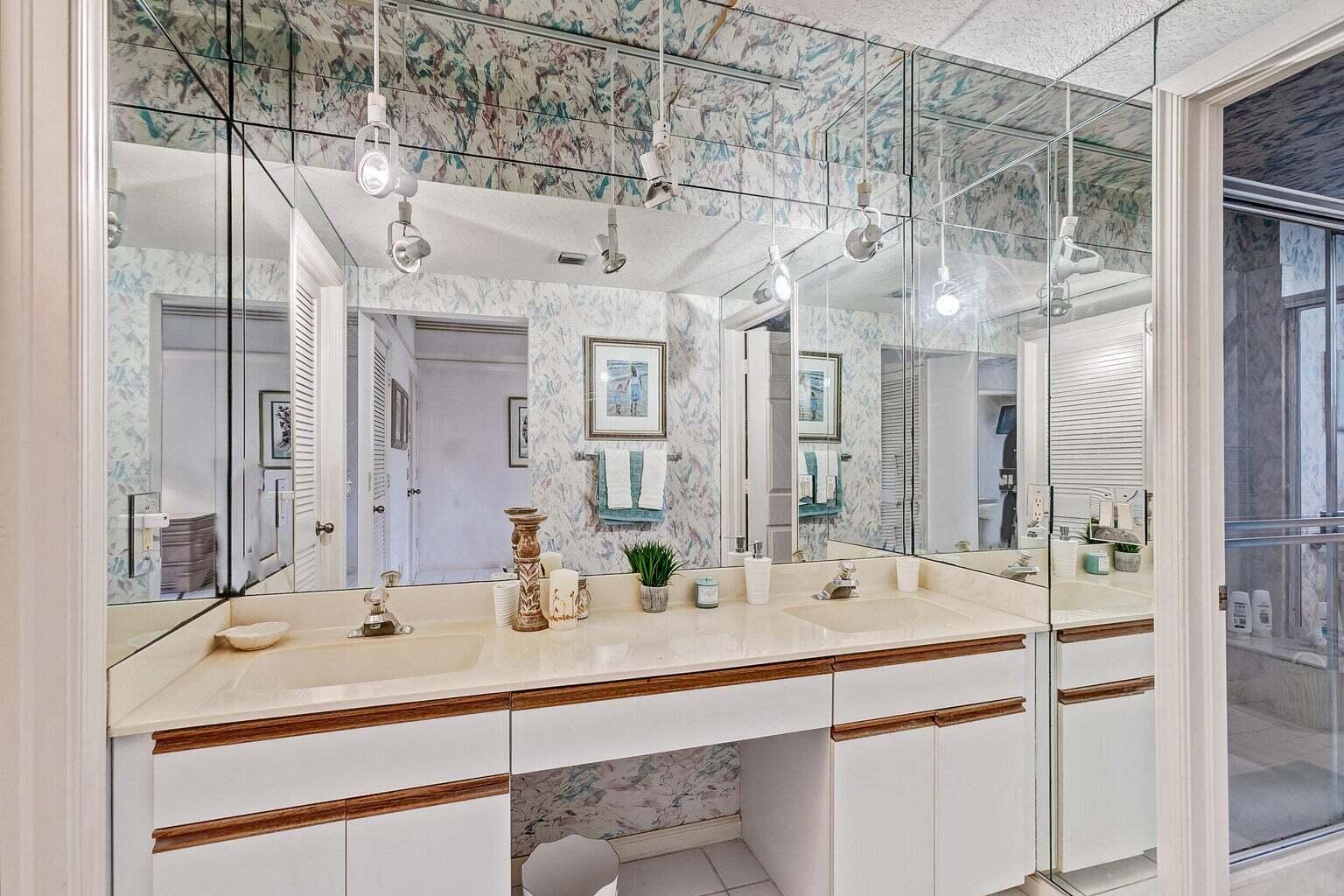 16151 West Bay Drive, Unit 161 Jupiter, FL 33477 - Photo 7 of 19 a bathroom with a sink and a mirror