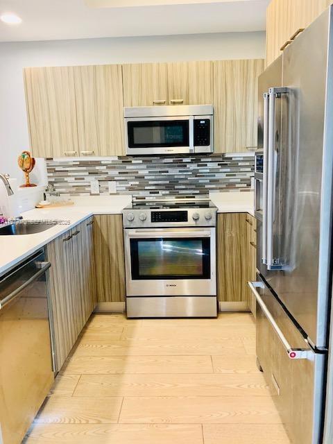 619 Meridian Avenue, Unit 4 Miami Beach, FL 33139 - Photo 16 of 30 a kitchen with granite countertop a stove microwave and refrigerator