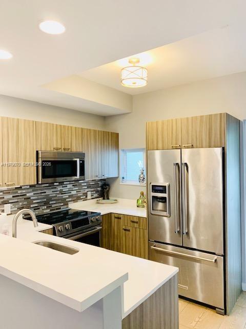 619 Meridian Avenue, Unit 4 Miami Beach, FL 33139 - Photo 17 of 30 a kitchen with a refrigerator a stove a sink and a oven