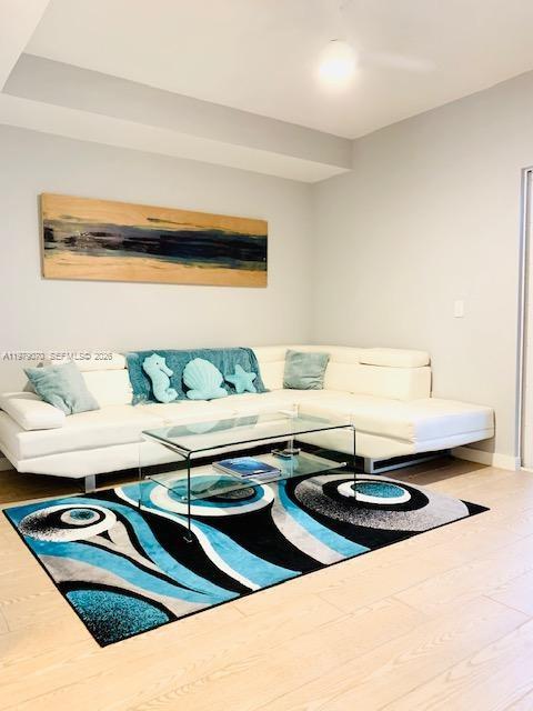 619 Meridian Avenue, Unit 4 Miami Beach, FL 33139 - Photo 9 of 30 a living room with a table and a lamp