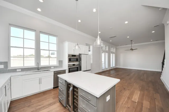 a kitchen with a stove a sink and a refrigerator