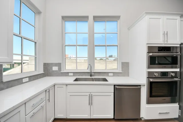 a kitchen with granite countertop a sink and a window