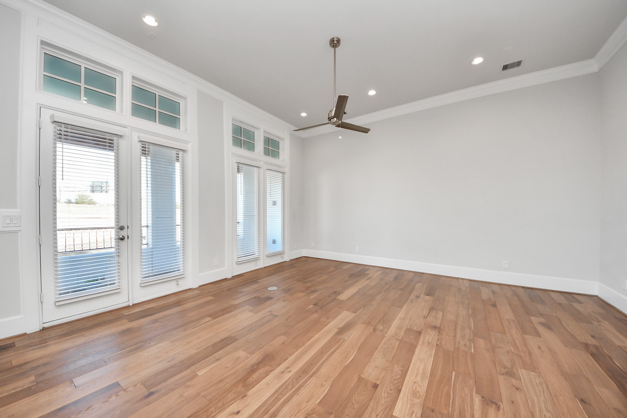 826 Cage Street Houston, TX 77020 - Photo 17 of 45 a view of an empty room with wooden floor and a window