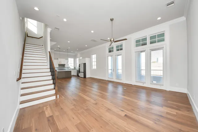 a view of a room with wooden floor and stairs