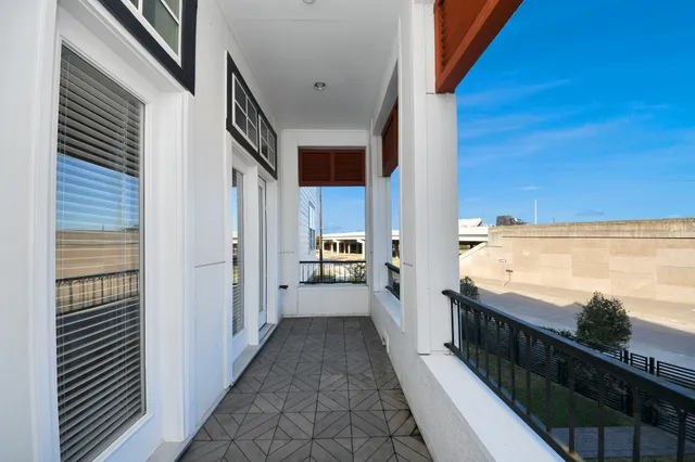 a view of a balcony next to a yard