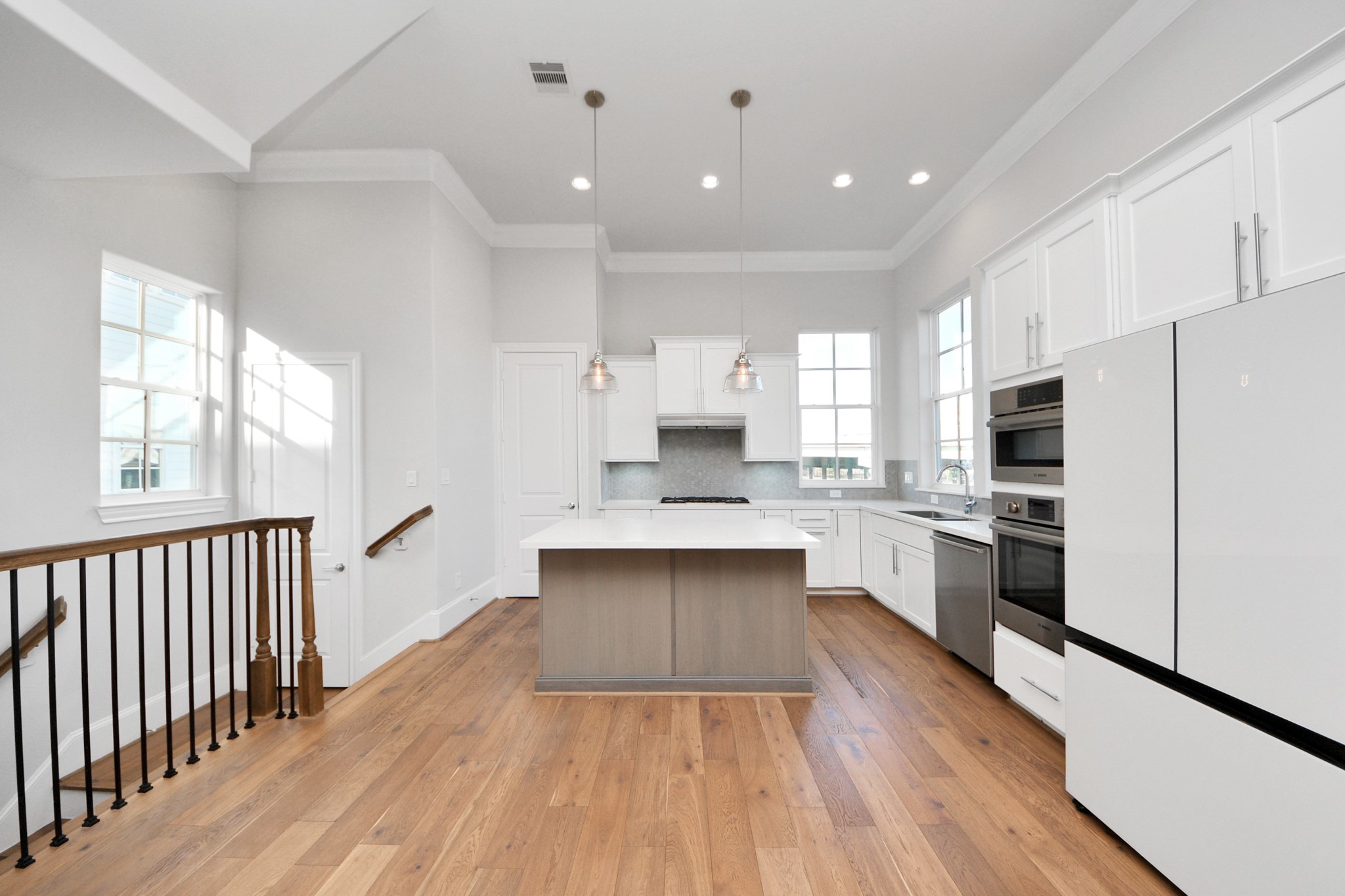826 Cage Street Houston, TX 77020 - Photo 21 of 45 a large kitchen with cabinets wooden floor and stainless steel appliances