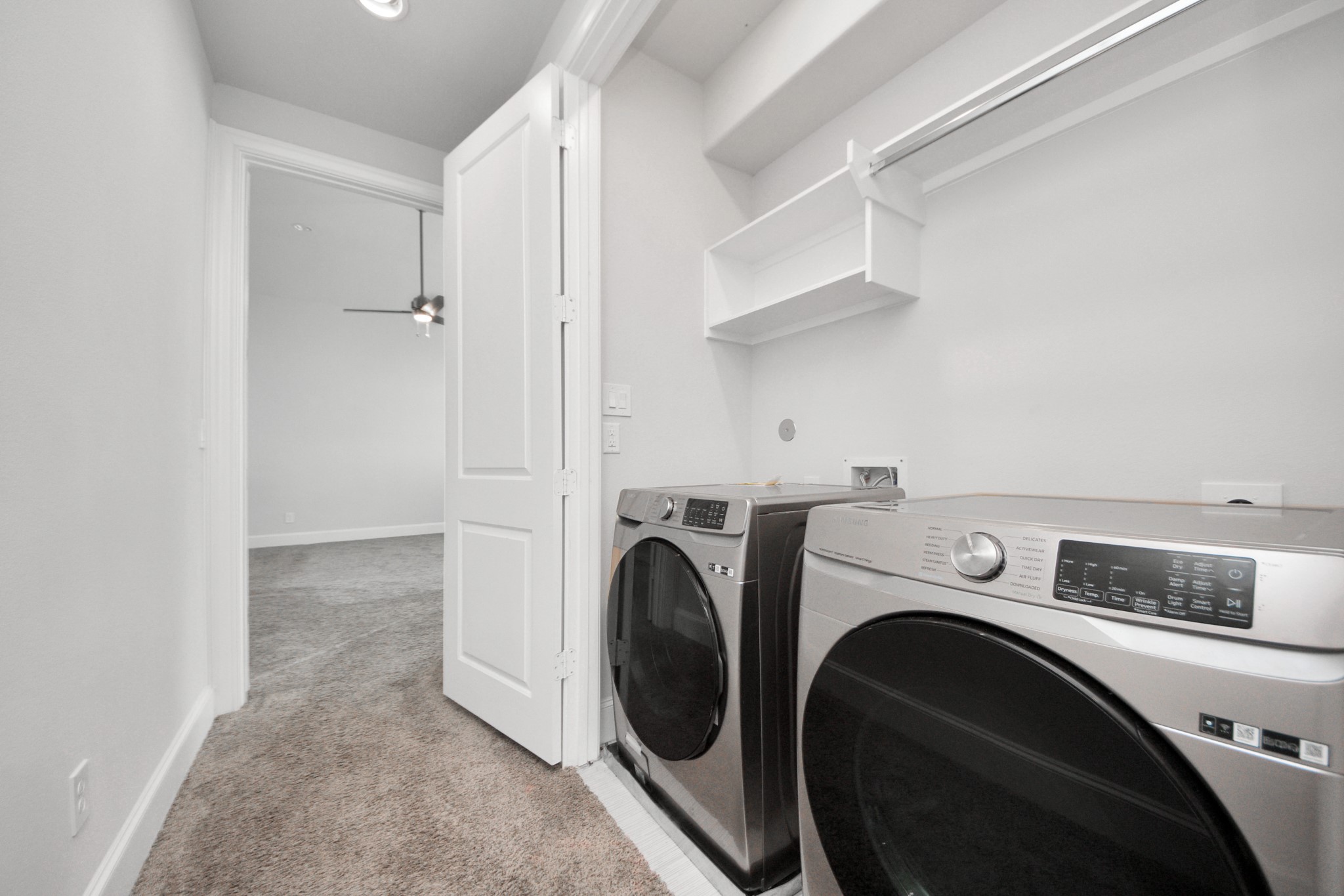 826 Cage Street Houston, TX 77020 - Photo 24 of 45 a view of washer and dryer with kitchen in the background