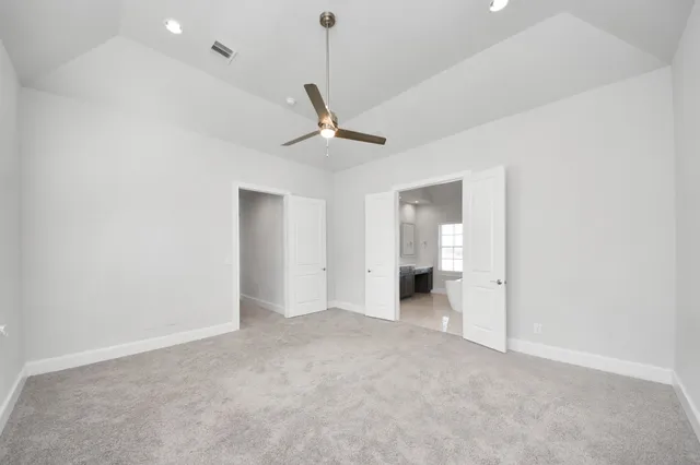 a view of a livingroom with a ceiling fan and window