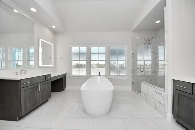 a large white kitchen with a large window