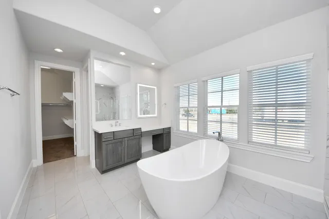 a large spacious bathroom with a large tub and shower