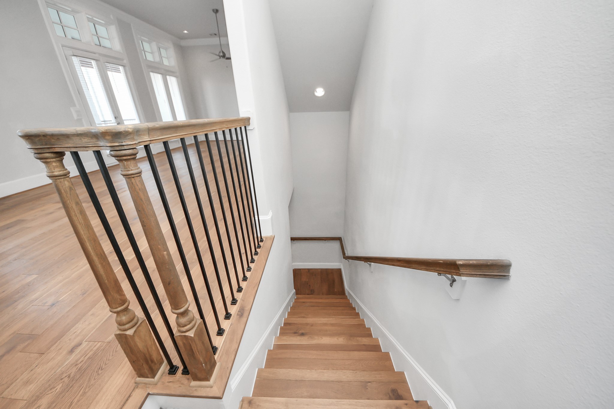 826 Cage Street Houston, TX 77020 - Photo 8 of 45 a view of a hallway with wooden floor and staircase