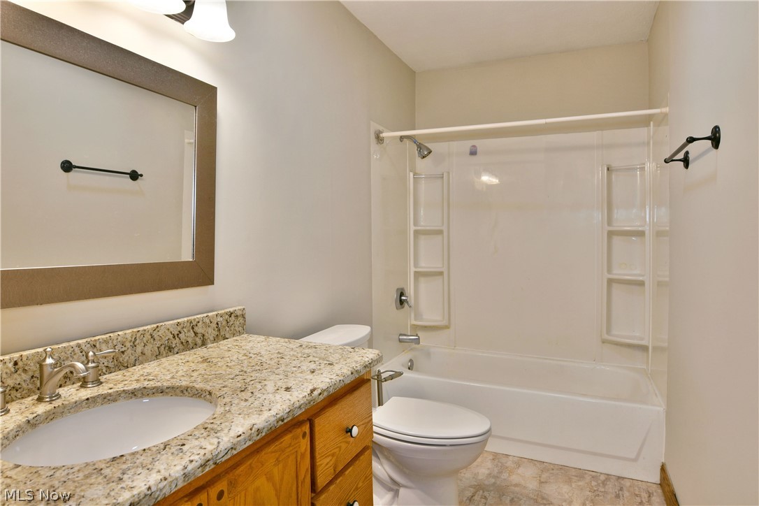 754 Warner Road Hubbard, OH 44425 - Photo 22 of 46 Bathroom featuring a vanity with a light-toned countertop, an undermount sink, and a wood-finish cabinet