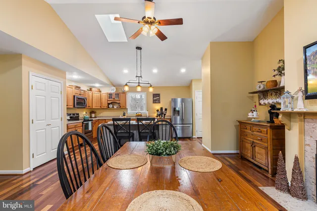 a view of a dining room with furniture a chandelier and wooden floor