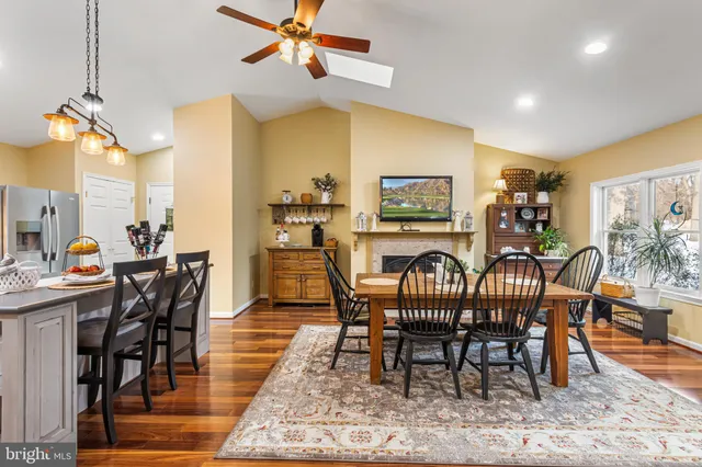 a dining room with furniture a rug and wooden floor