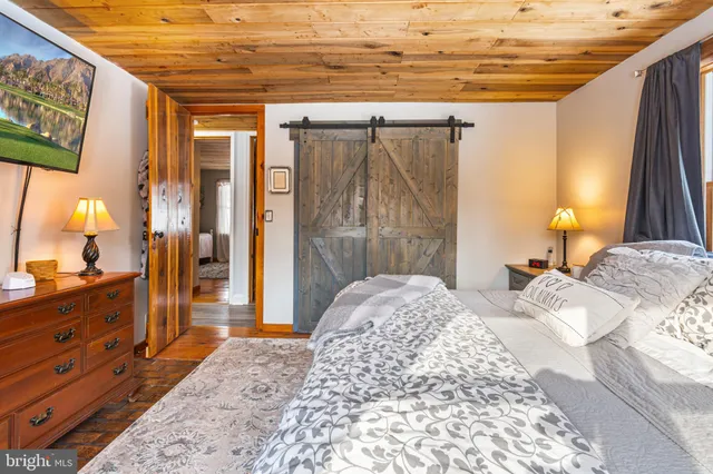 a bedroom with a bed and a mirror