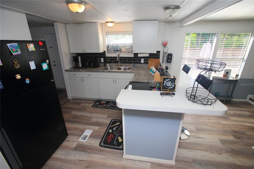 131 Southwest 76th Terrace Ocala, FL 34474 - Photo 11 of 27 a kitchen with a table chairs and a refrigerator