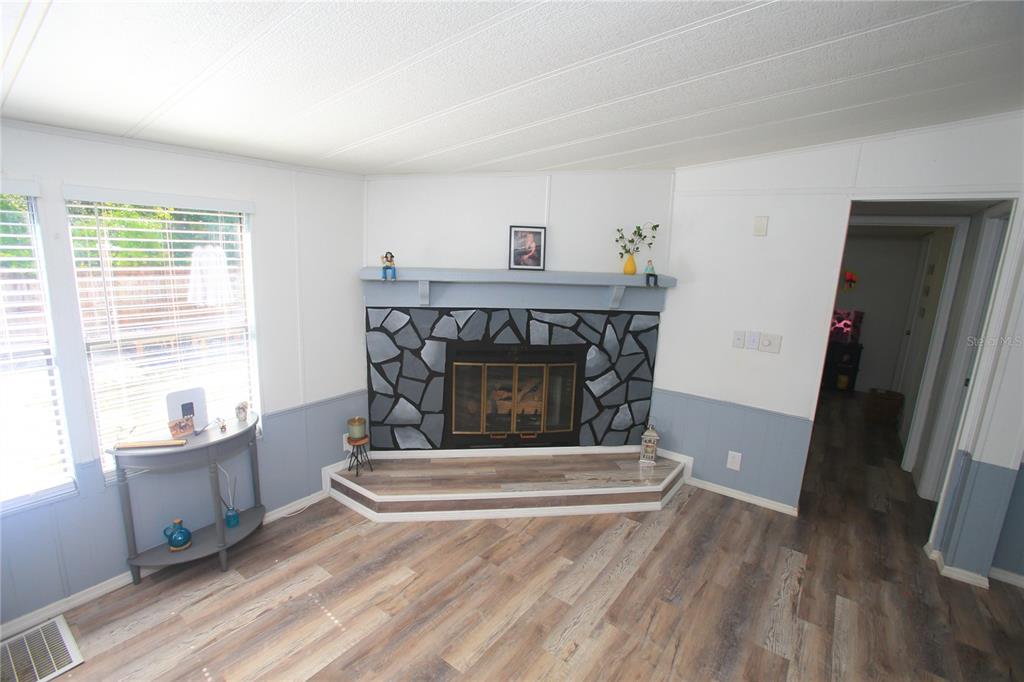 131 Southwest 76th Terrace Ocala, FL 34474 - Photo 12 of 27 a living room with furniture and a fireplace