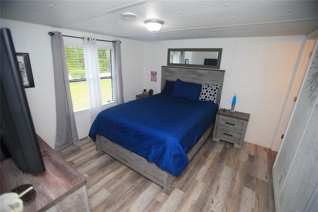 131 Southwest 76th Terrace Ocala, FL 34474 - Photo 16 of 27 a bedroom with a bed and wooden floor