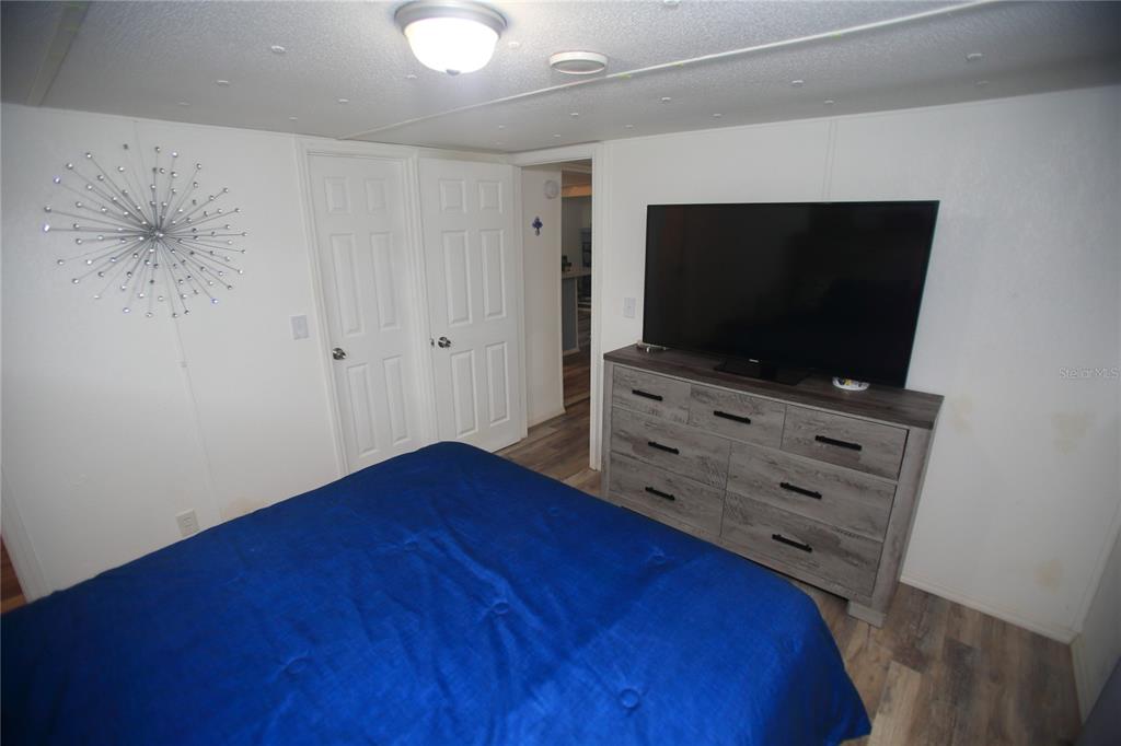 131 Southwest 76th Terrace Ocala, FL 34474 - Photo 18 of 27 a room with wooden floor and flat screen tv