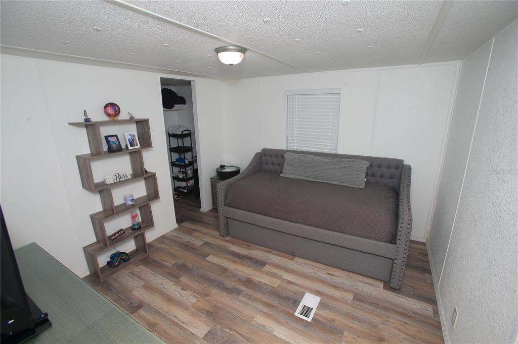 131 Southwest 76th Terrace Ocala, FL 34474 - Photo 21 of 27 a bedroom with a bed and a couch