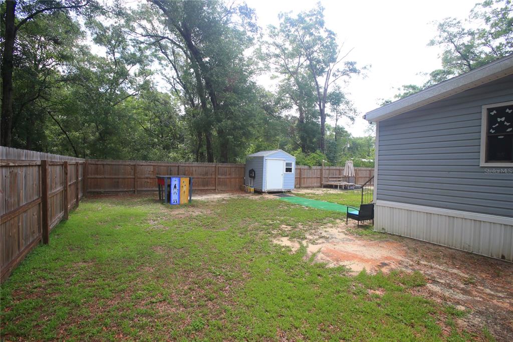 131 Southwest 76th Terrace Ocala, FL 34474 - Photo 4 of 27 a backyard of a house with entertaining space