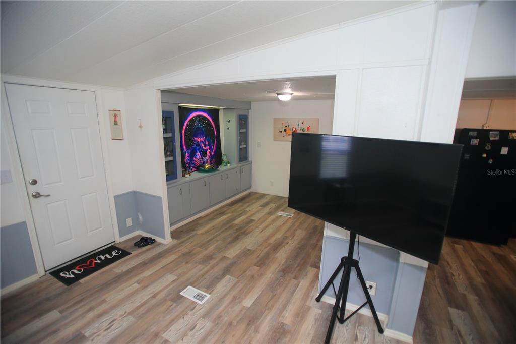 131 Southwest 76th Terrace Ocala, FL 34474 - Photo 7 of 27 a view of a room with gym equipment and a flat screen tv