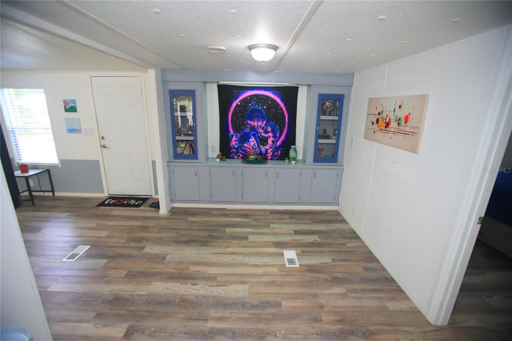131 Southwest 76th Terrace Ocala, FL 34474 - Photo 8 of 27 a view of an empty room with wooden floor