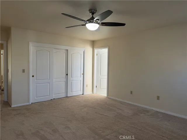 a bathroom with a granite countertop sink a toilet and mirror