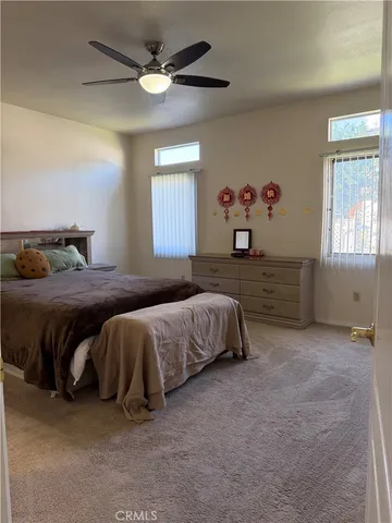 a bedroom with a bed and ceiling fan