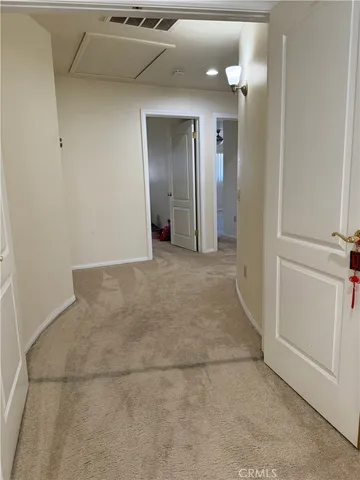 a view of a hallway with stairs