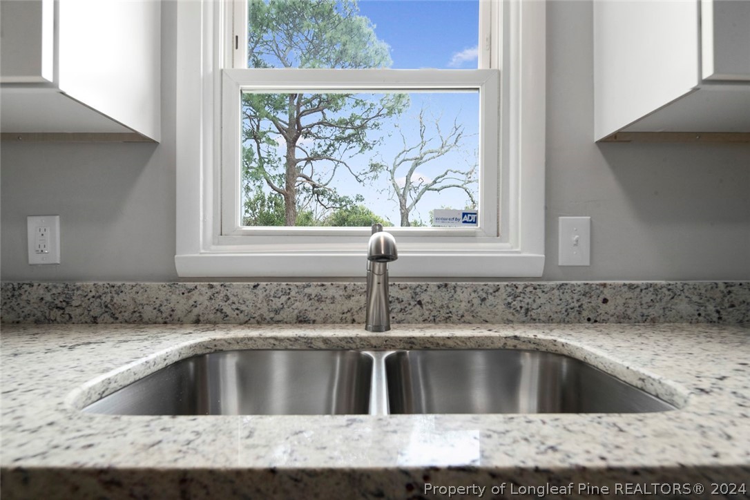 1604 Shaw Road Fayetteville, NC 28311 - Photo 12 of 30 a kitchen with a sink window and cabinets