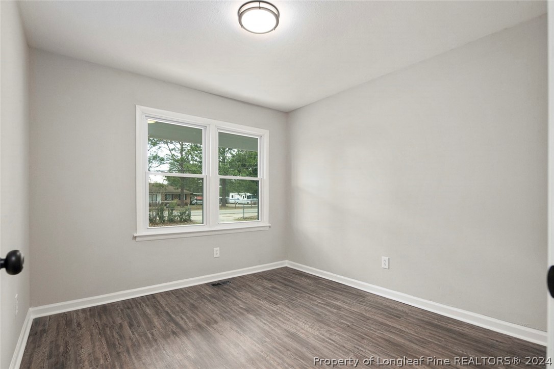 1604 Shaw Road Fayetteville, NC 28311 - Photo 17 of 30 an empty room with wooden floor and windows