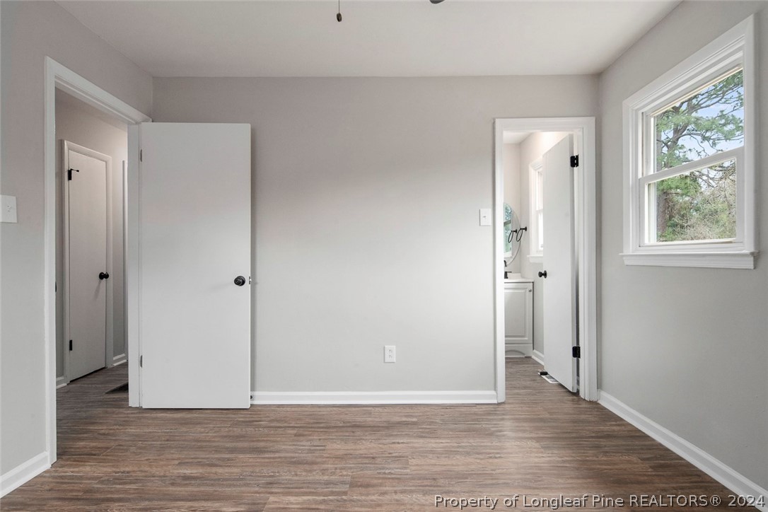 1604 Shaw Road Fayetteville, NC 28311 - Photo 22 of 30 a view of an empty room with wooden floor and a window