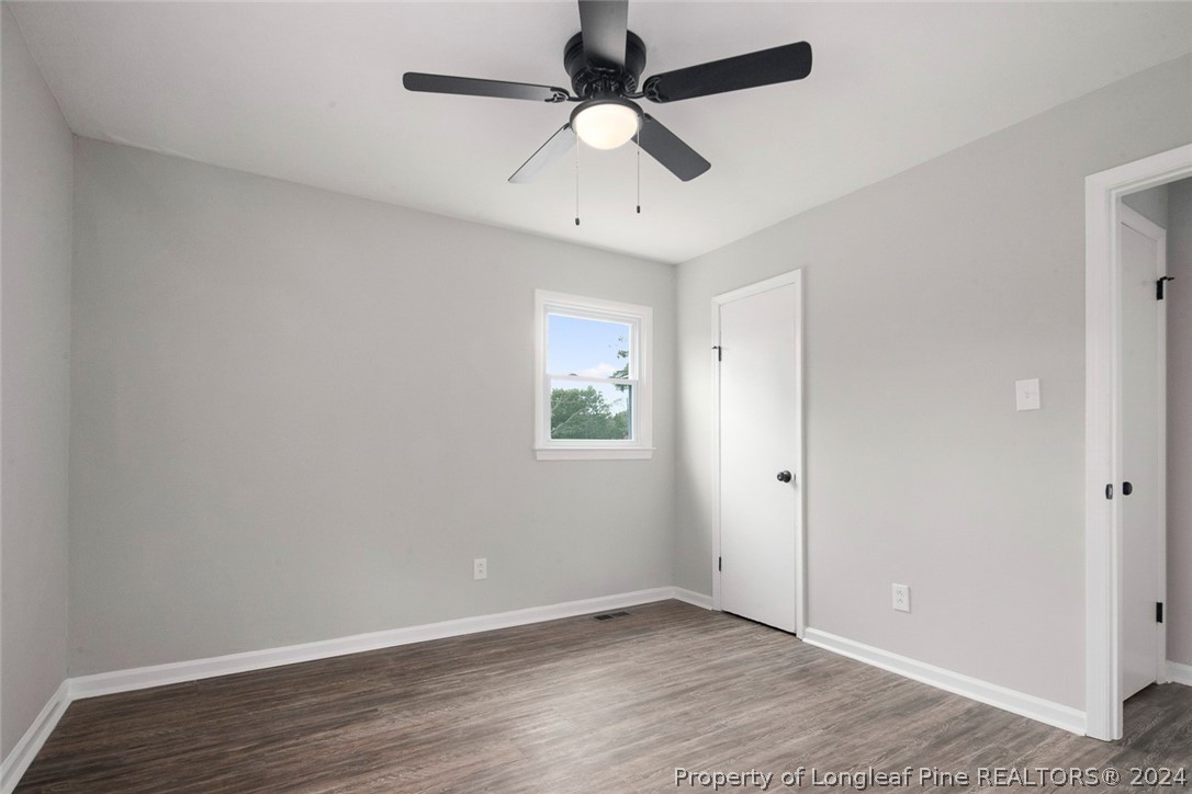 1604 Shaw Road Fayetteville, NC 28311 - Photo 23 of 30 an empty room with a window and a ceiling fan