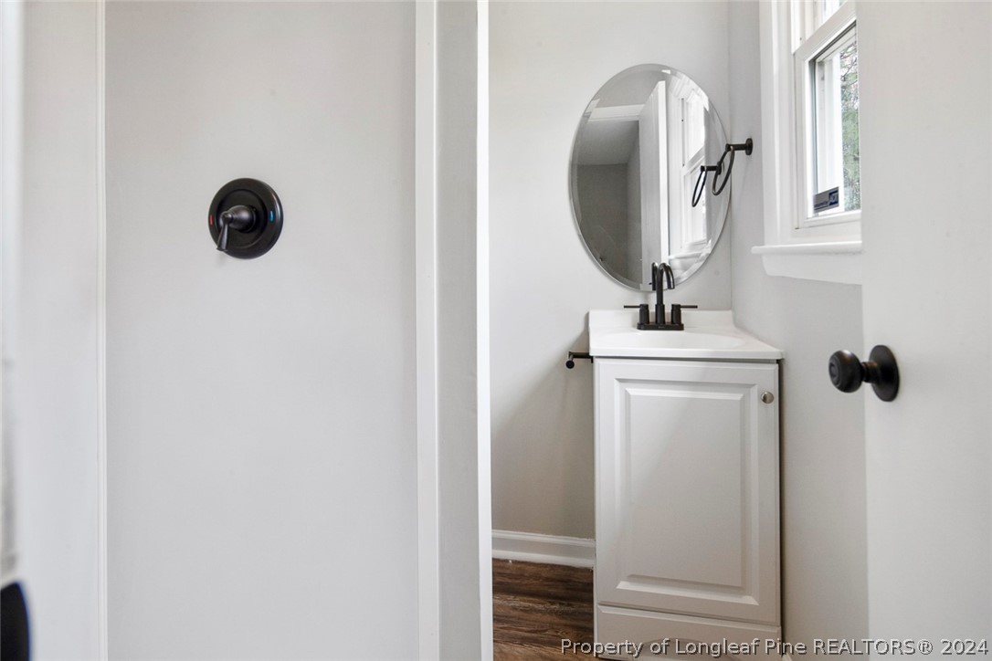 1604 Shaw Road Fayetteville, NC 28311 - Photo 24 of 30 a bathroom with a mirror and a shower