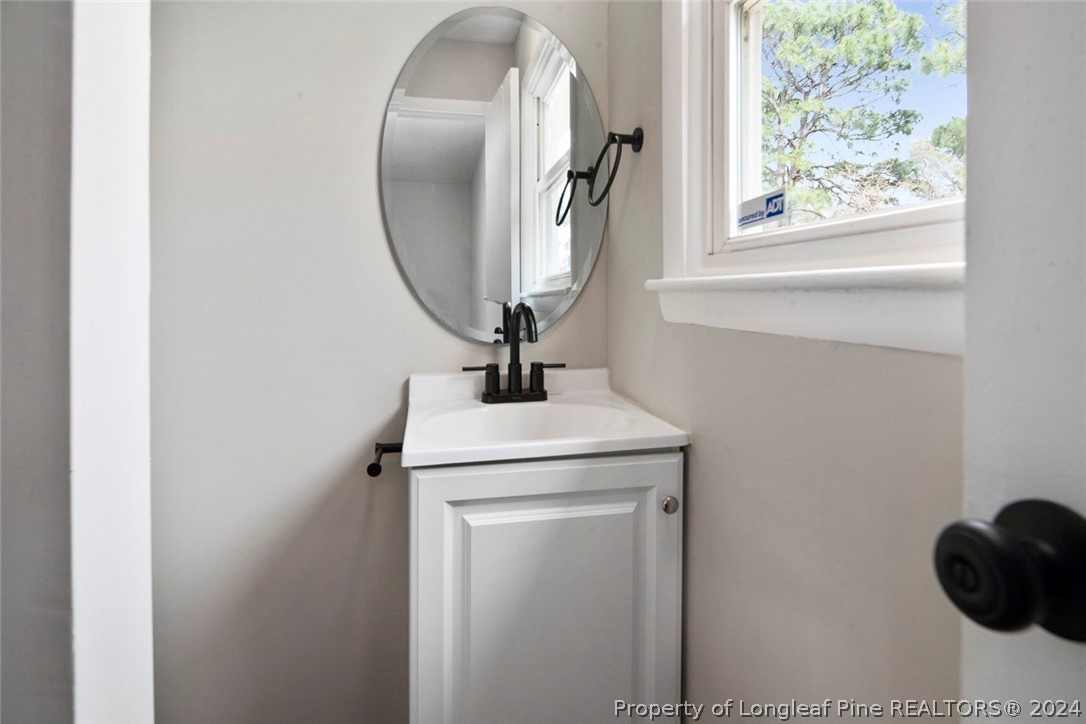1604 Shaw Road Fayetteville, NC 28311 - Photo 25 of 30 a bathroom with a sink and a mirror
