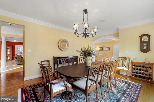 a living room with furniture a ceiling fan and a large window