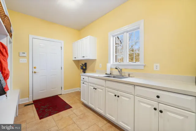 a spacious bathroom with a tub sink and mirror