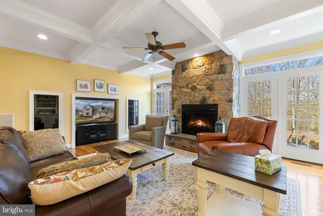 a living room with furniture rug and wooden floor