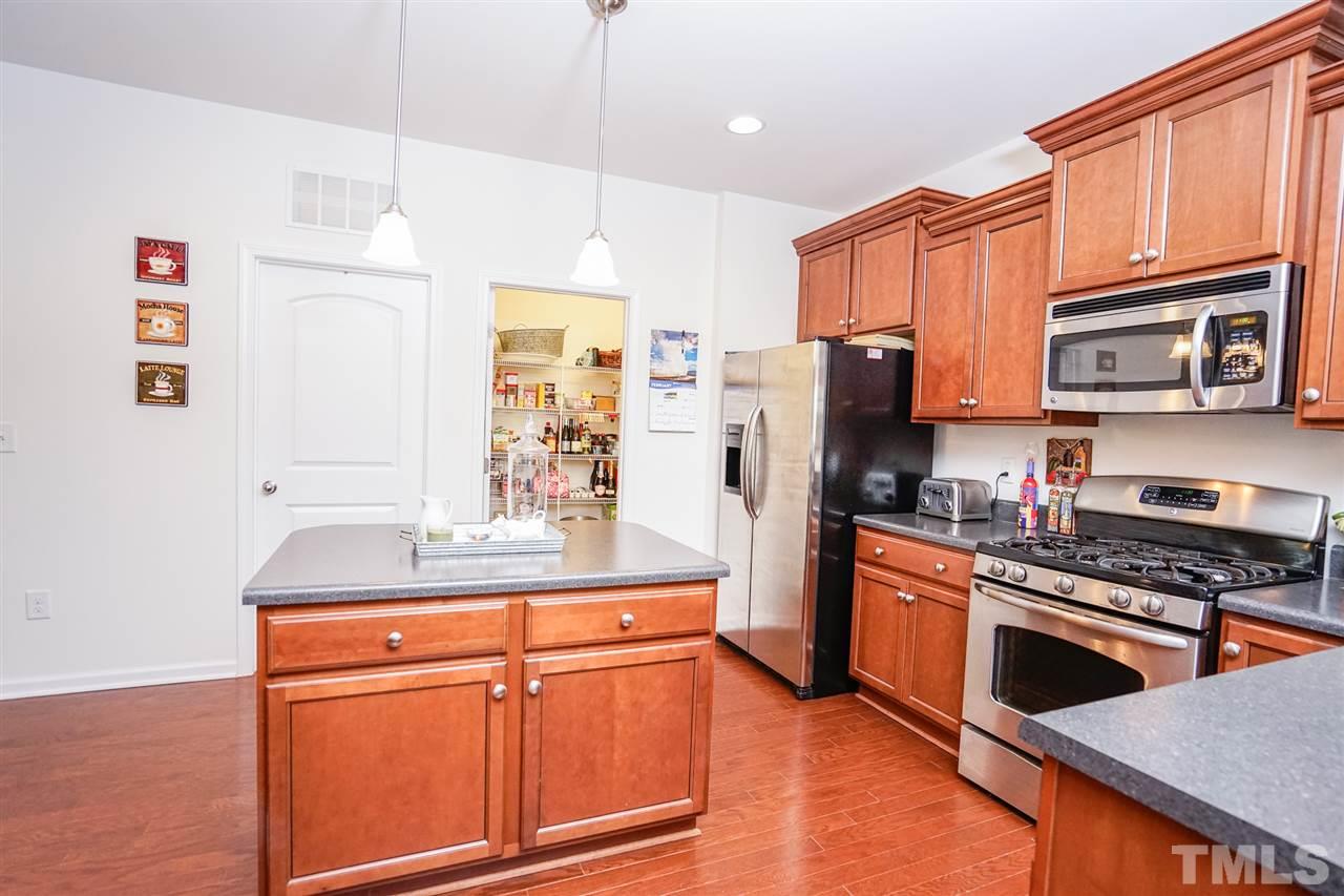 Gas stove. birch wood cabinets, lots of counter space & added prep space with island plus a large pantry.