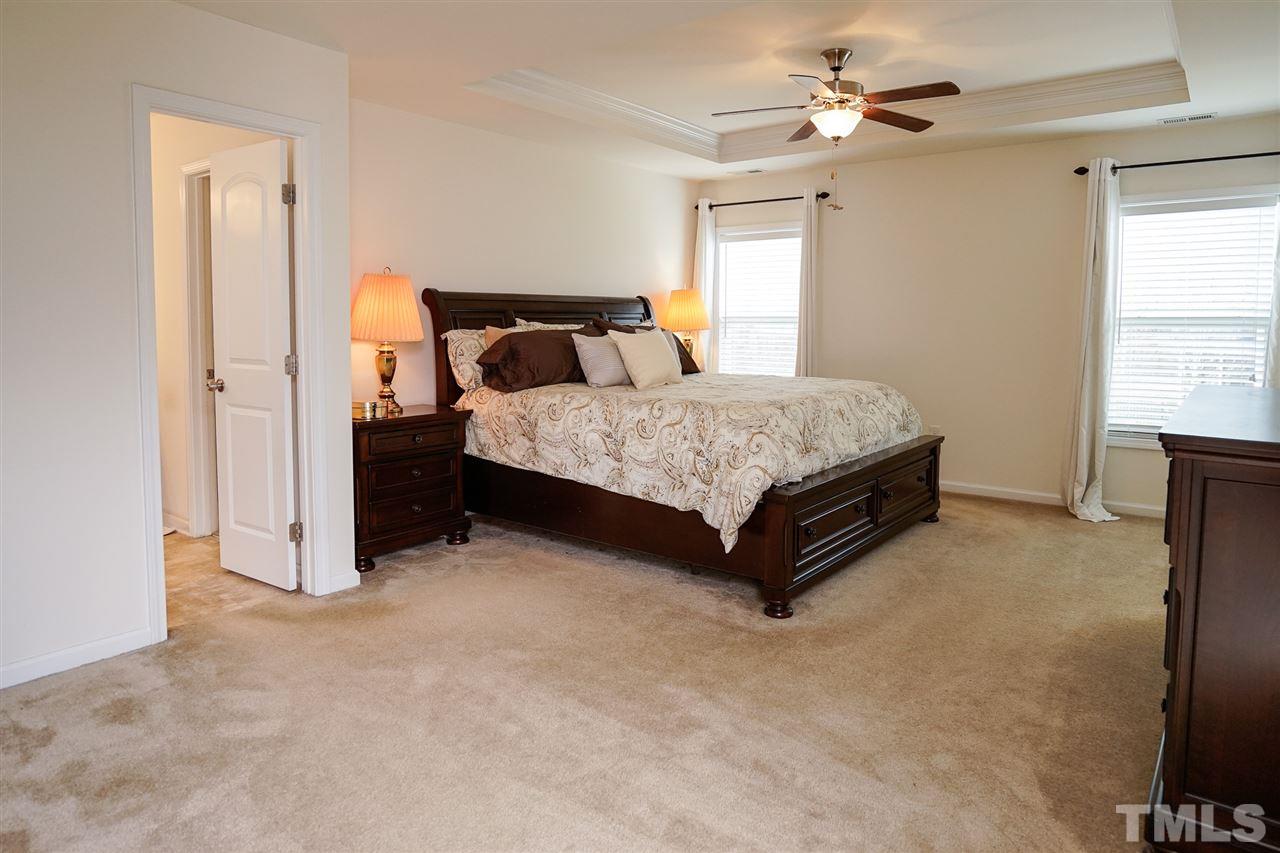 1604 Pattersons Mill Road Durham, NC 27703 - Photo 11 of 30 Master large enough for king bed and side tables The retreat features his and hers closets, sitting area and attractive tray ceiling.