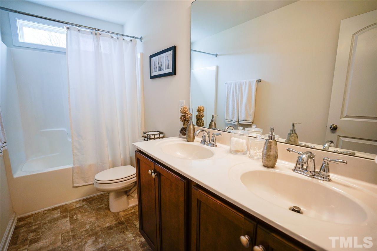 1604 Pattersons Mill Road Durham, NC 27703 - Photo 19 of 30 Main bath on second floor features double sinks and transom windows adding natural light.